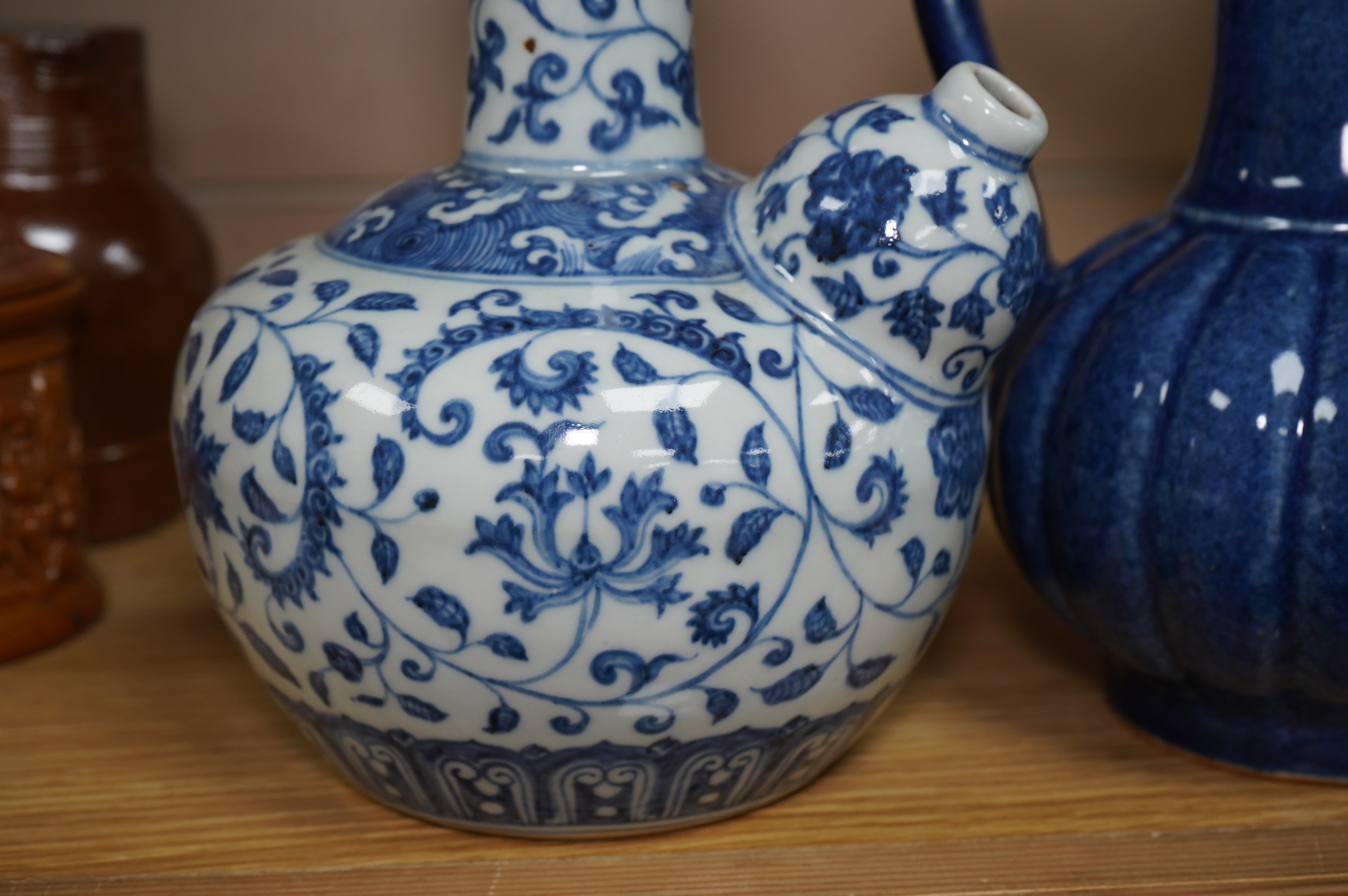 A Chinese porcelain powder blue ewer with cover and a similar blue and white example, largest 25cm high. Condition - good